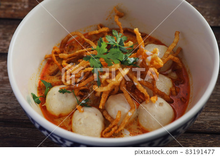 Local northern Thai food Egg noodle curry with meatballs on wood background 83191477
