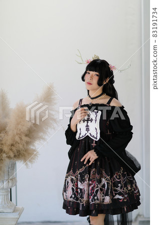 Portrait of asian girl in lolita fashion dress in vintage garden background Portrait of asian girl in lolita fashion dress in vintage garden background 83191734
