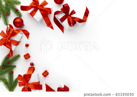 Christmas background with red decorations, baubles, fir tree branches, gift boxes Christmas background with red decorations, baubles, fir tree branches, gift boxes 83193030