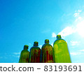 Lined empty bottles and blue sky 83193691