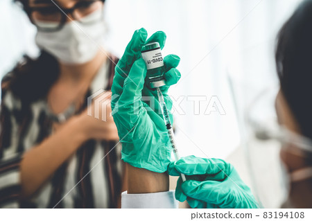 Young woman visits skillful doctor at hospital for vaccination 83194108