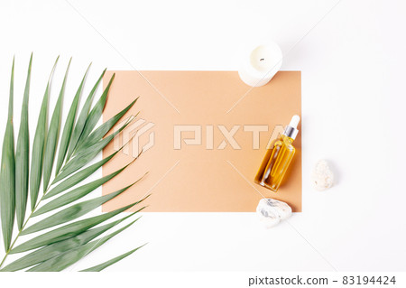 Natural organic cosmetic oil bottle on brown blank card template Natural organic cosmetic oil bottle on brown blank card template 83194424