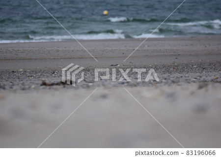 Different focuses of a beach against the ocean with a small floating buoy 83196066