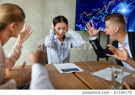 Workplace Bullying. Aggressive Coleagues Shouting At Stressed Asian Female Employee In Office 83196179