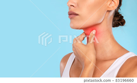 Young woman suffering from sore throat, blue studio Young woman suffering from sore throat, blue studio 83196660