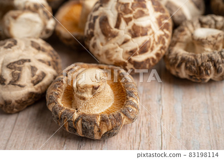 Dried shiitake mushroom on wooden background. Healthy food. Dried shiitake mushroom on wooden background. Healthy food. 83198114