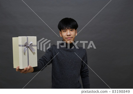 Christmas party man holding gift box 83198849