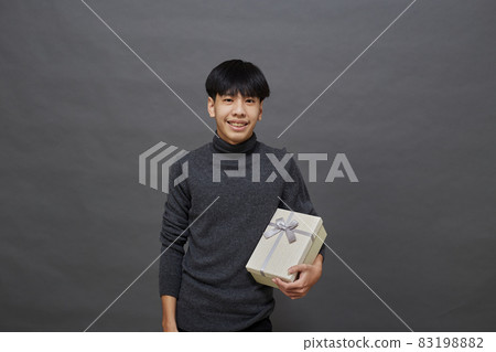 Christmas party man holding gift box 83198882