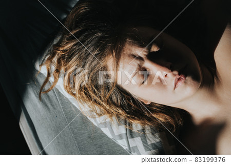 Portrait of a sleeping caucasian woman in the morning sun. Portrait of a sleeping caucasian woman in the morning sun. 83199376