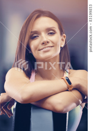Portrait of young brown-haired woman outdoor at sport playground. Caucasian fitness girl during workout. Sport and health care concept 83199853
