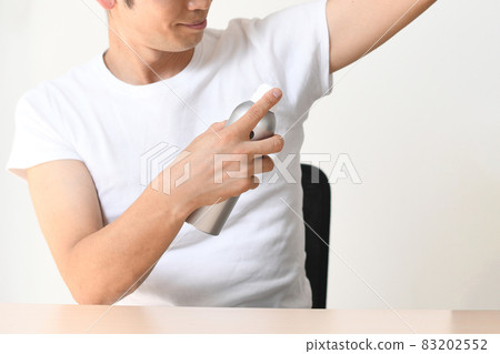 Image of a man with antiperspirant spray (deodorant) on his side Image of a man with antiperspirant spray (deodorant) on his side 83202552