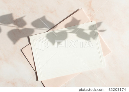 Card mock-up with plant shadow on pink marble background 83205174