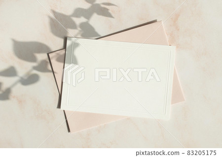 Card mock-up with plant shadow on pink marble background 83205175