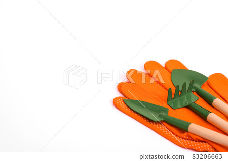 Mini tools for flowers - shovel, rake. Protective knitted point gloves for gardening. On a white background. copy space. layout.  83206663