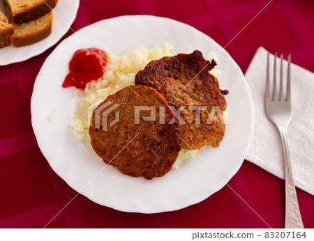 Traditional dish of Russian cuisine is cutlets with rice 83207164