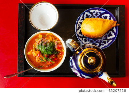 Uzbek soup laghman served with samsa 83207216