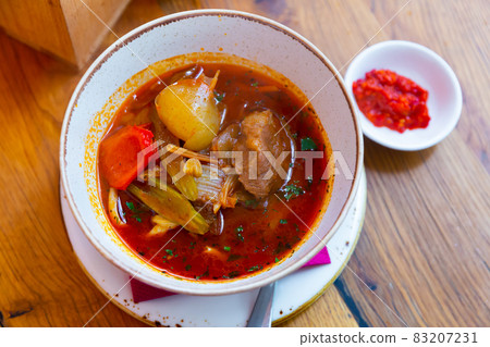 National dish Uyghur laghman on wooden table 83207231