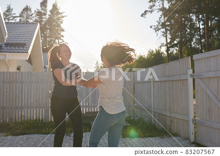 Two friends have fun on a day off. They jump, hug and laugh together, positive emotions. High quality photo Two friends have fun on a day off. They jump, hug and laugh together, positive emotions. High quality photo 83207567