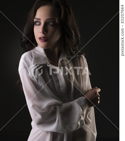 Sexy brunette in shirt cropped view in dark room Sexy brunette in shirt cropped view in dark room 83207664