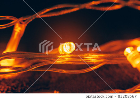 Illuminated garland close up on dark background 83208567