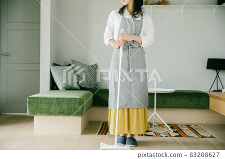 Woman cleaning Woman wearing a handy mop Woman cleaning Woman wearing a handy mop 83208627