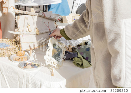 A woman looking at handmade miscellaneous goods at Marche 83209210