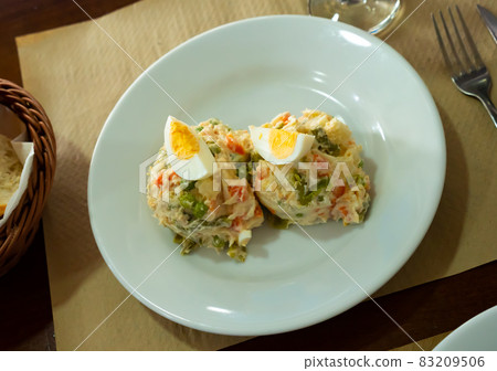 Banquet in restaurant - Spanish salad with potatoes, tuna, olives and egg 83209506