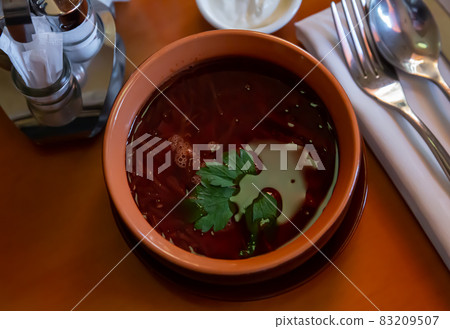 Traditional Ukrainian red borscht in meat broth with greens Traditional Ukrainian red borscht in meat broth with greens 83209507