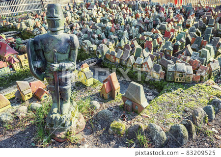 Figure of a knight against the background of a model of medieval Koenigsberg in Svetlogorsk 83209525