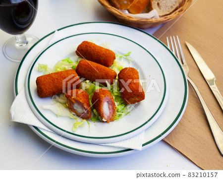 Spanish flamenquines, breaded pork loin rolled with serrano ham 83210157