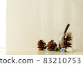 Image of pine cones and twigs placed in an empty bottle and placed in the corner 83210753