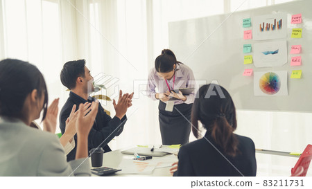 Businesswoman proficiently present work project receive celebrations from team Businesswoman proficiently present work project receive celebrations from team 83211731