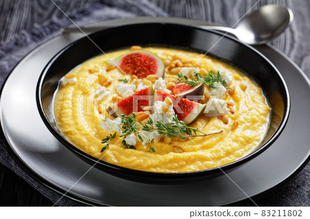 Pumpkin cream soup with thyme with feta and figs 83211802
