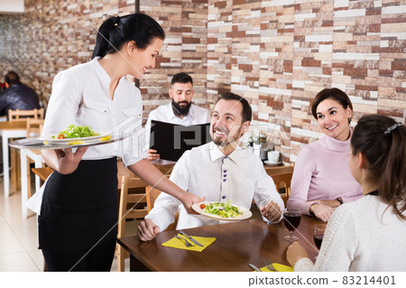 Waitress taking table order at tavern Waitress taking table order at tavern 83214401