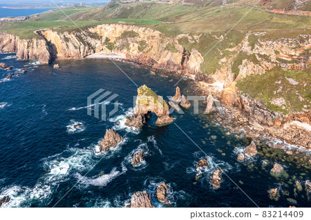 Aerial view of the rocks in the sea at Crohy Head Sea Arch, County Donegal - Ireland. Aerial view of the rocks in the sea at Crohy Head Sea Arch, County Donegal - Ireland. 83214409