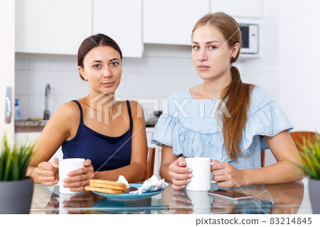 Upset young women discussing, quarrel during drinking tea at home kitchen 83214845