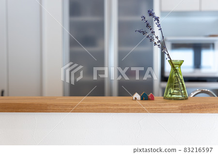 A cute little wooden house on the kitchen counter 83216597