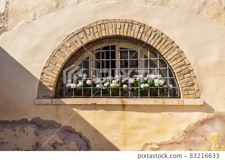 Window with Brick Arch and Wrought Iron Security Bars - Lazise village Italy 83216633