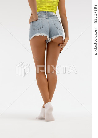 Provocative woman showing buttocks in studio 83217898