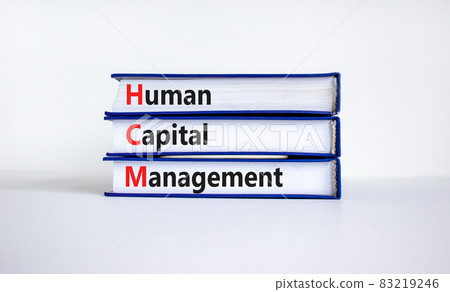 HCM, Human capital management symbol. Concept words HCM, Human capital management on books on a beautiful white background. Business, HCM, Human capital management concept. Copy space. 83219246