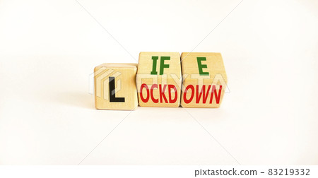 Life with lockdown symbol. Turned wooden cubes and changed words 'lockdown' to'life'. Beautiful white background. Covid-19 pandemic and life with lockdown concept. Copy space. 83219332