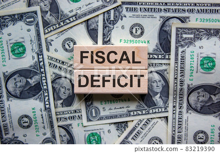 Concept words 'fiscal deficit' on wooden blocks on a beautiful background from dollar bills. Business concept. Concept words 'fiscal deficit' on wooden blocks on a beautiful background from dollar bills. Business concept. 83219390