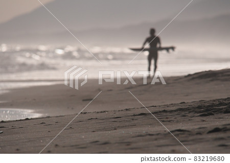 Atsumi Peninsula, a surfer standing in the evening view of the Omotehama coast 83219680