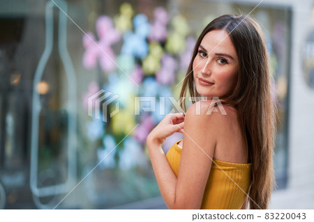 portrait of a young woman dressed in fashion looking at camera 83220043