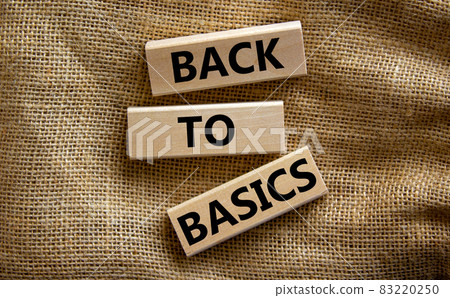 Wooden blocks form the words 'back to basics' on canvas background. Business and educational concept. Wooden blocks form the words 'back to basics' on canvas background. Business and educational concept. 83220250