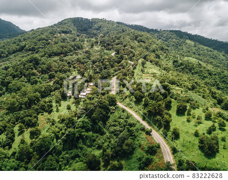 Aerial view of the road lead to top of Doi Pha Hi an intricate mountain range in Mae Sai district of Chiang Rai province of Thailand in rainy season. Aerial view of the road lead to top of Doi Pha Hi an intricate mountain range in Mae Sai district of Chiang Rai province of Thailand in rainy season. 83222628