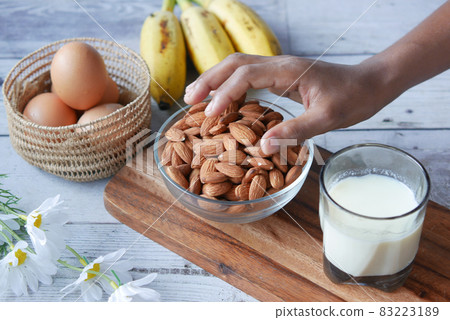 hand pick almond nut with egg and milk on table hand pick almond nut with egg and milk on table 83223189