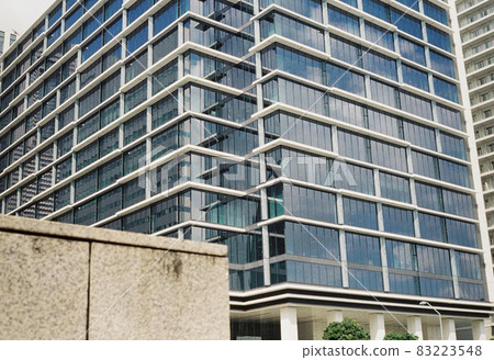 The blue sky reflected in the glass of the building 83223548
