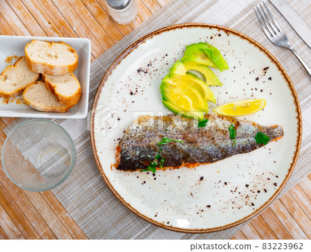 Just cooked roasted trout with avocado Just cooked roasted trout with avocado 83223962
