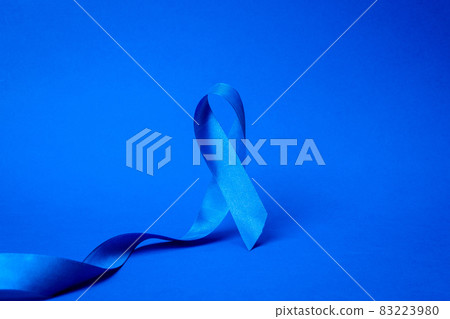 Men cancer. Awareness of men health in November with blue prostate cancer ribbon isolated on deep blue background. Adrenocortical carcinoma concept. 83223980